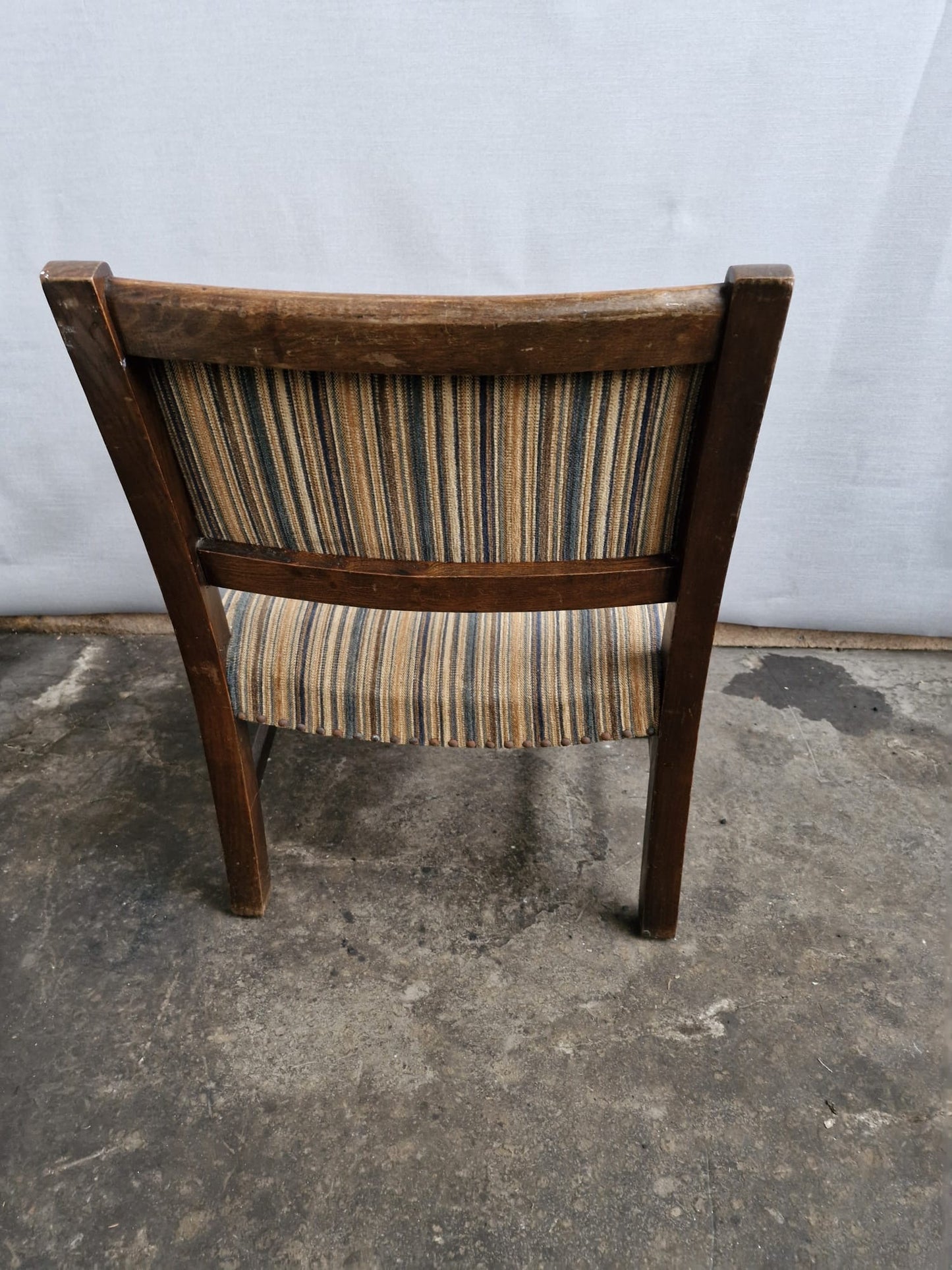 A Small vintage carved oak framed kids armchair with upholstered seat