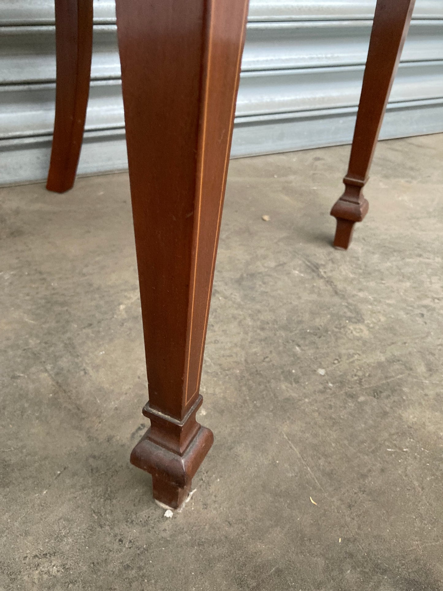 Single antique dining chair with floral seat and gold inlaid trim on back rest