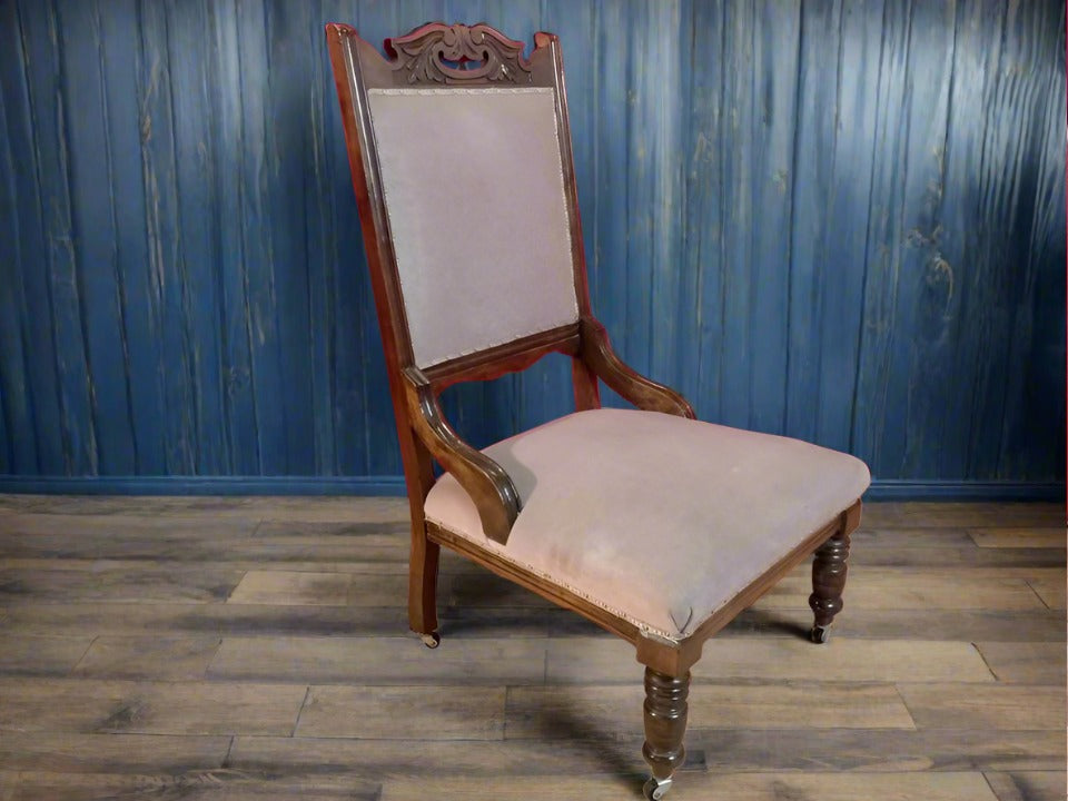 Carved oak antique upholstered nursing chair on castors