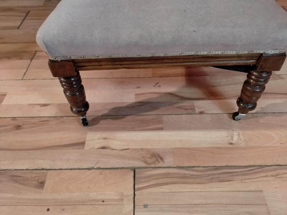 Carved oak antique upholstered nursing chair on castors