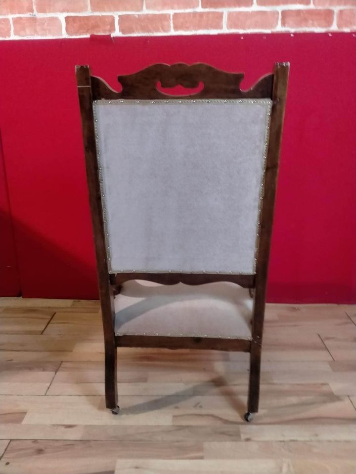 Carved oak antique upholstered nursing chair on castors