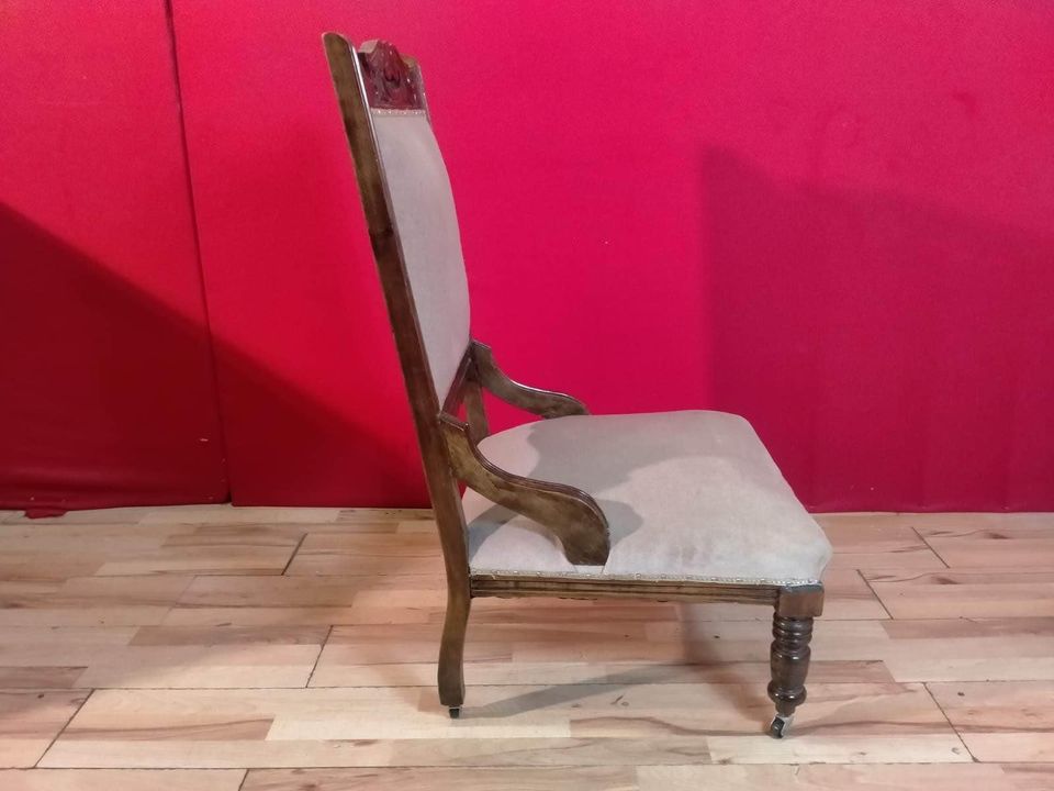 Carved oak antique upholstered nursing chair on castors